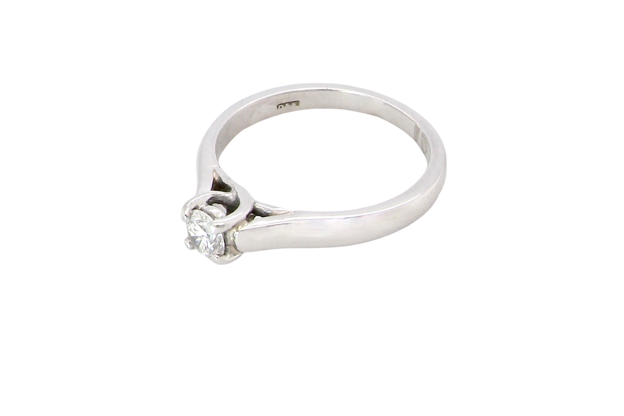 side A single stone solitaire diamond ring. The modern brilliant cut white diamond measures 3.9mm (0.22 carats est) Colour G-h, clarity VS.