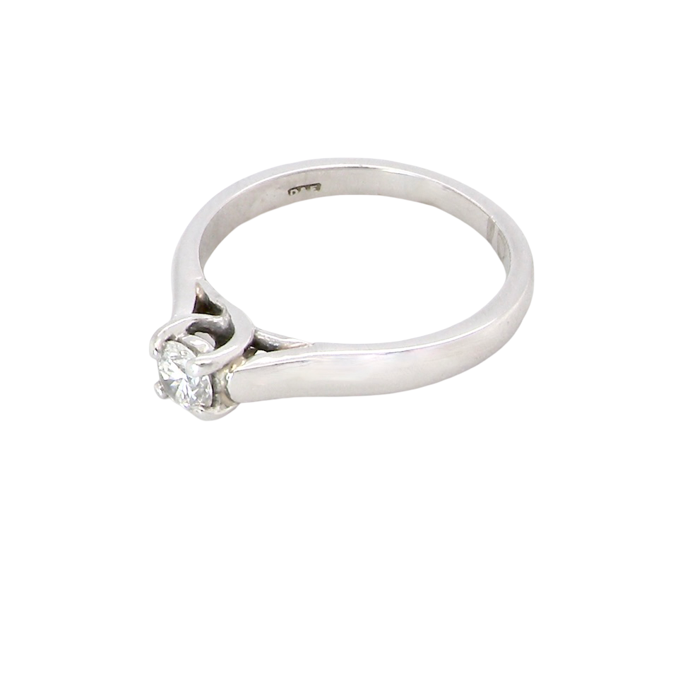 side A single stone solitaire diamond ring. The modern brilliant cut white diamond measures 3.9mm (0.22 carats est) Colour G-h, clarity VS.