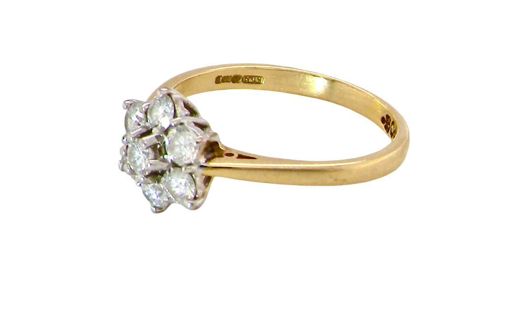 side A small cluster ring set with seven bright white brilliant cut white diamonds.
Head measures 8.5mm, each diamond measures 2.8mm (total 0.50 carats