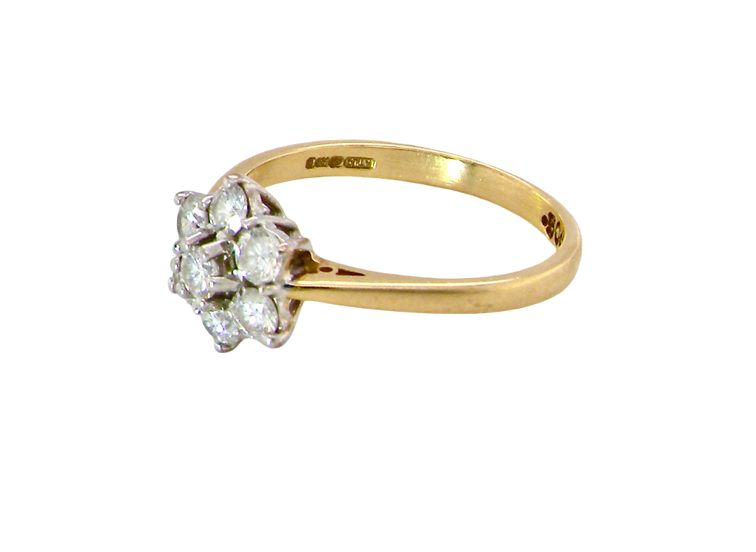 side A small cluster ring set with seven bright white brilliant cut white diamonds.
Head measures 8.5mm, each diamond measures 2.8mm (total 0.50 carats