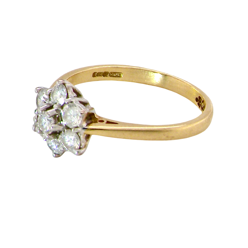 side A small cluster ring set with seven bright white brilliant cut white diamonds.
Head measures 8.5mm, each diamond measures 2.8mm (total 0.50 carats