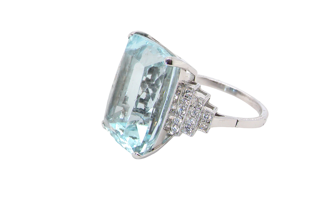 side A spectacular vintage statement ring, centred with an impressive rectangular-cut aquamarine of exceptional proportions. Measuring approximately 18 x 13mm with a depth of 11mm, the aquamarine is estimated to weigh around 18 carats