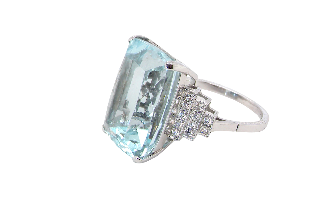 side A spectacular vintage statement ring, centred with an impressive rectangular-cut aquamarine of exceptional proportions. Measuring approximately 18 x 13mm with a depth of 11mm, the aquamarine is estimated to weigh around 18 carats