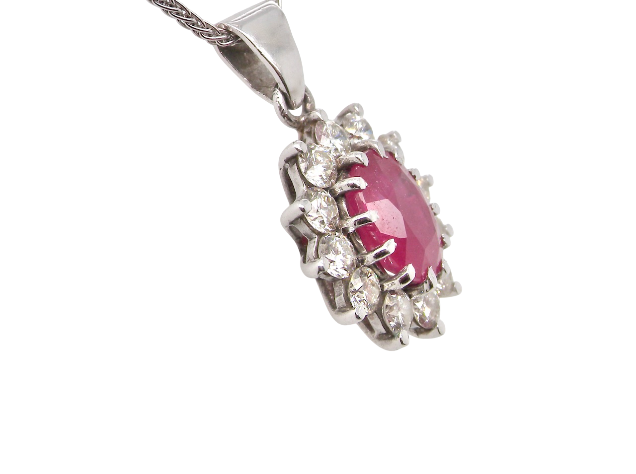 side A striking and elegant pendant crafted in 18-carat white gold, showcasing a vibrant oval-cut ruby of approximately 2.00 carats