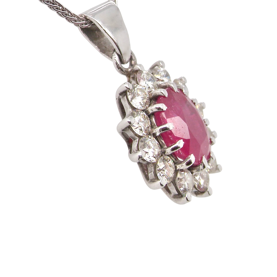 side A striking and elegant pendant crafted in 18-carat white gold, showcasing a vibrant oval-cut ruby of approximately 2.00 carats