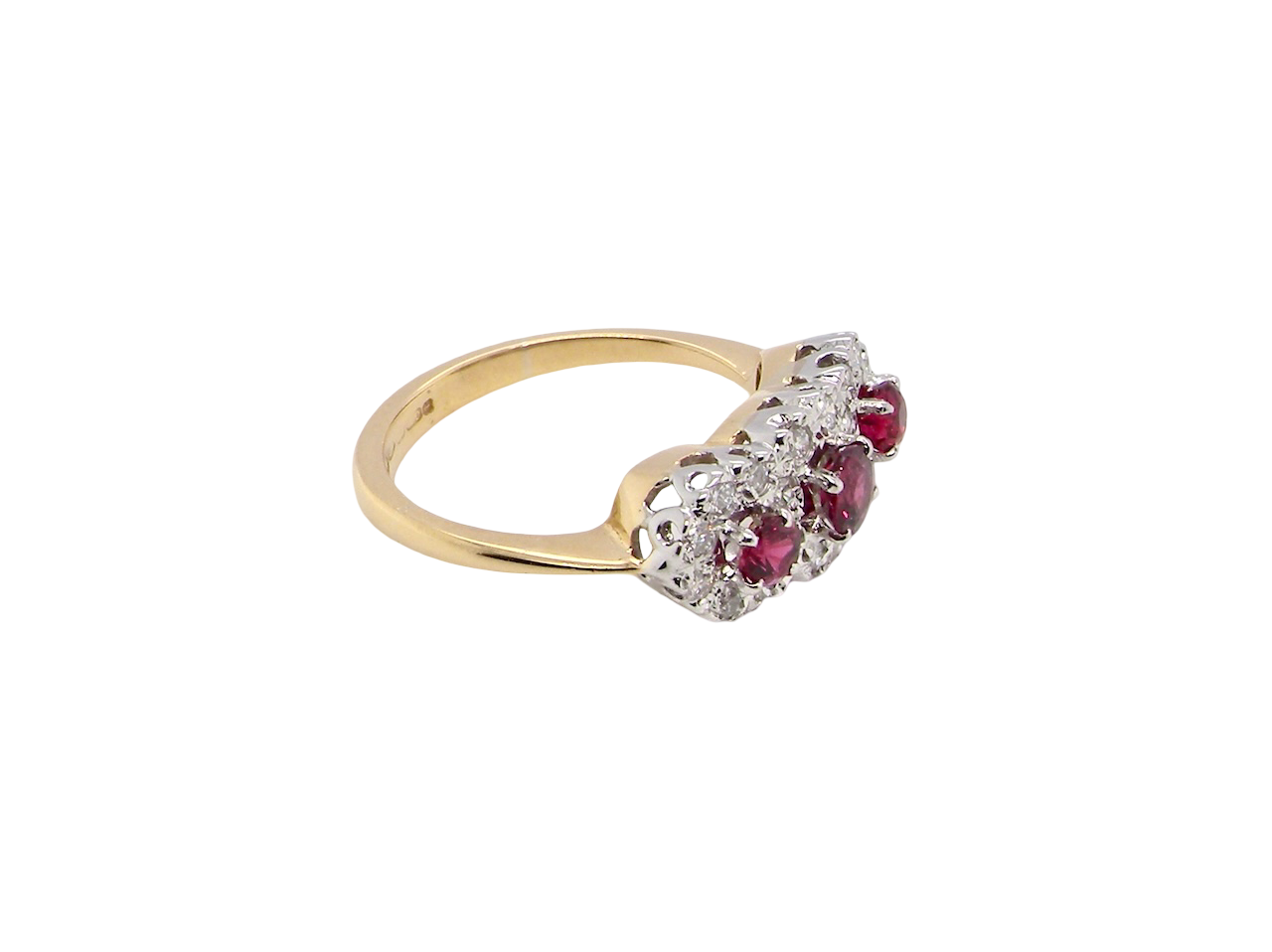 side A striking triple cluster ring crafted in 18 carat gold, dating circa 1990–2000, and fully hallmarked in the UK.
✨ Design & Gemstones
Three deep red rubies set to the centre of each cluster