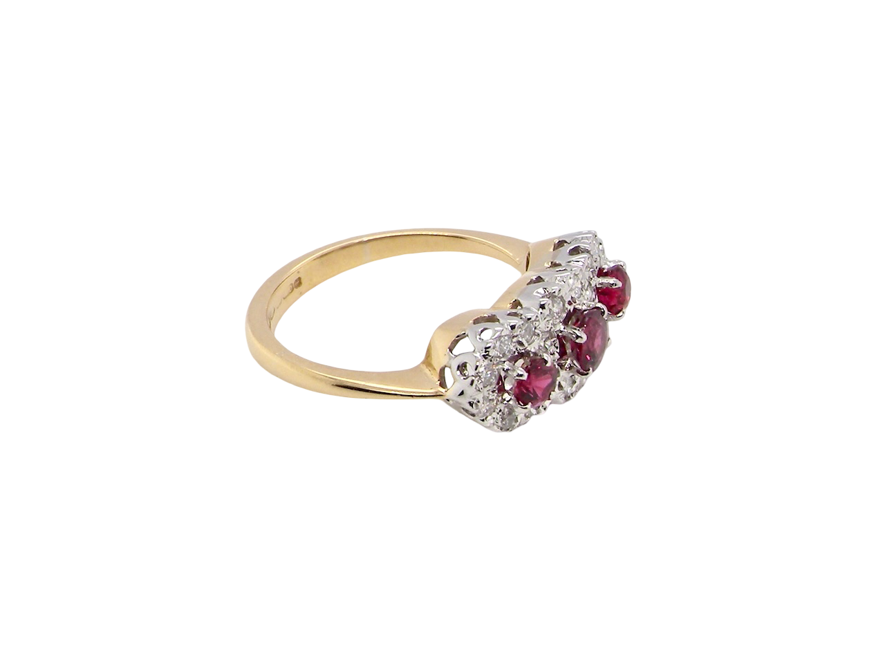 side A striking triple cluster ring crafted in 18 carat gold, dating circa 1990–2000, and fully hallmarked in the UK.
✨ Design & Gemstones
Three deep red rubies set to the centre of each cluster