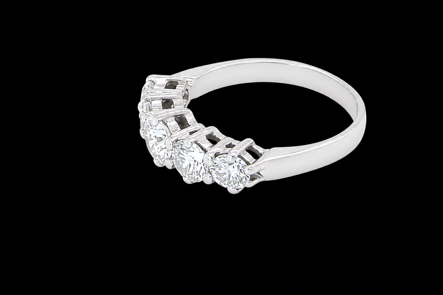 side A stunning half hoop ring featuring five exceptional brilliant-cut white diamonds, expertly claw set in 18ct white gold.
The centre diamond measures approximately 5.8mm (estimated 0.70 carats), flanked by a 5.0mm diamond on each side, with 4.5mm diamonds at each end.