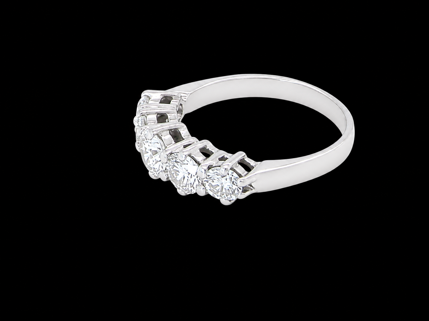 side A stunning half hoop ring featuring five exceptional brilliant-cut white diamonds, expertly claw set in 18ct white gold.
The centre diamond measures approximately 5.8mm (estimated 0.70 carats), flanked by a 5.0mm diamond on each side, with 4.5mm diamonds at each end.