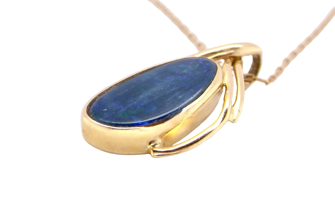 side A stunning pendant containing an oval shaped black opal