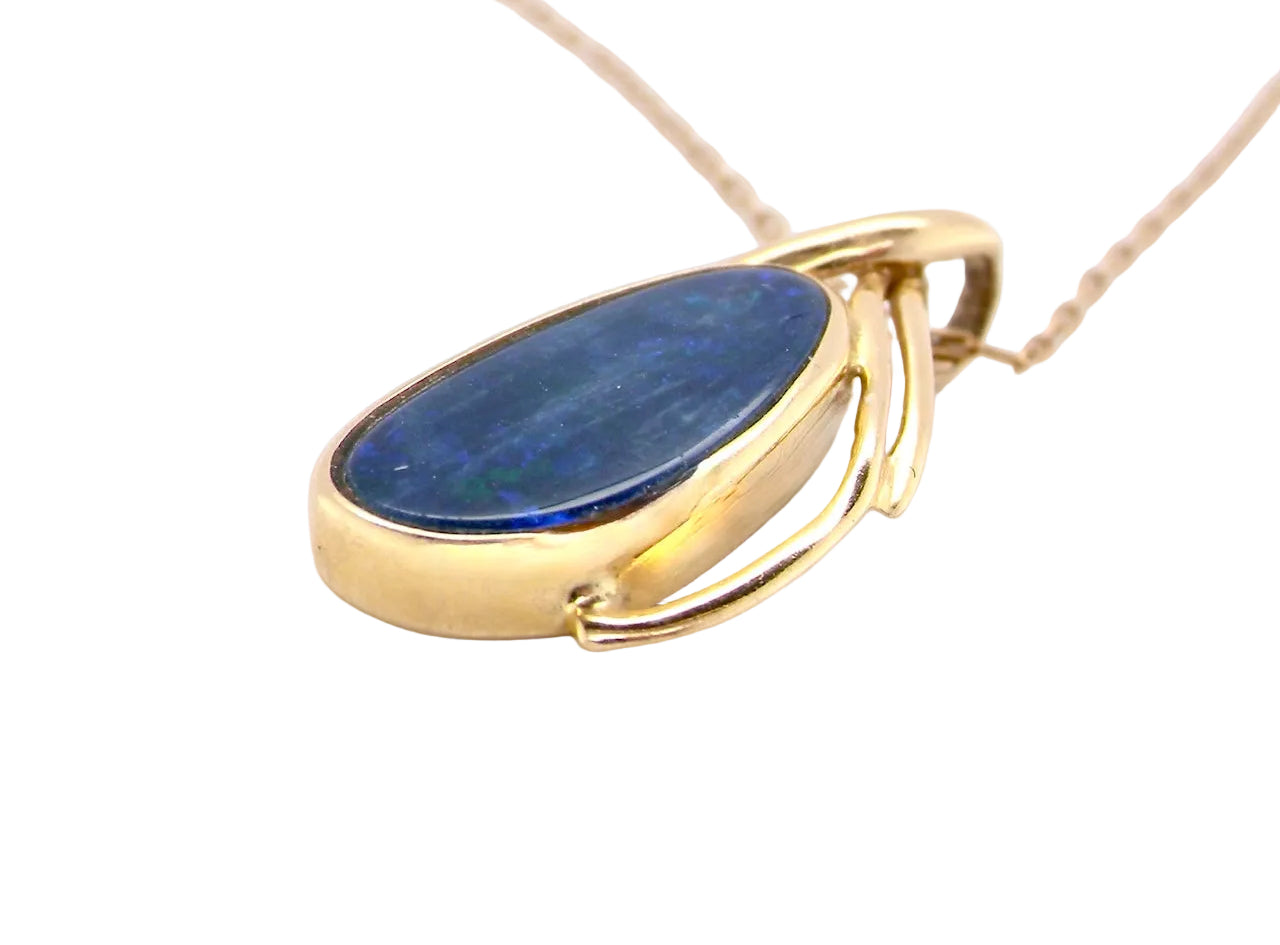 side A stunning pendant containing an oval shaped black opal