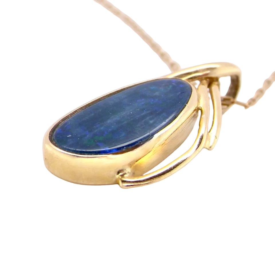 side A stunning pendant containing an oval shaped black opal
