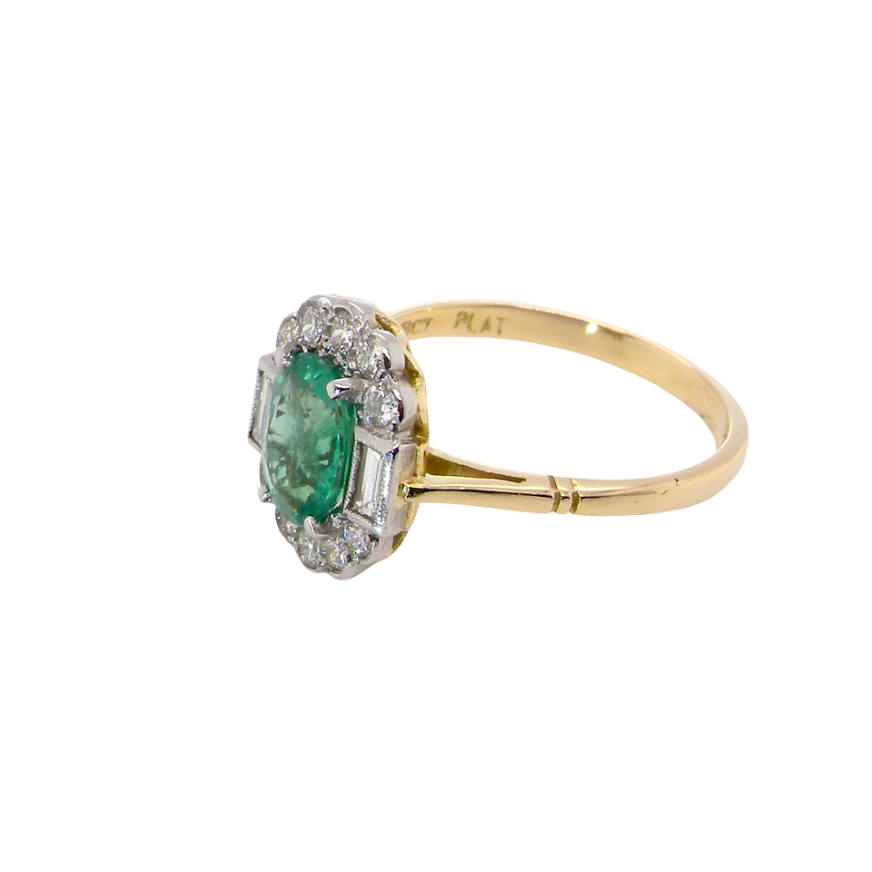 side A stunning vintage cluster ring, set with an oval-cut emerald measuring 8 x 6mm, approximately 1.10 carats. The emerald displays a rich, deep grass-green colour with natural inclusions, typical of a genuine stone.
