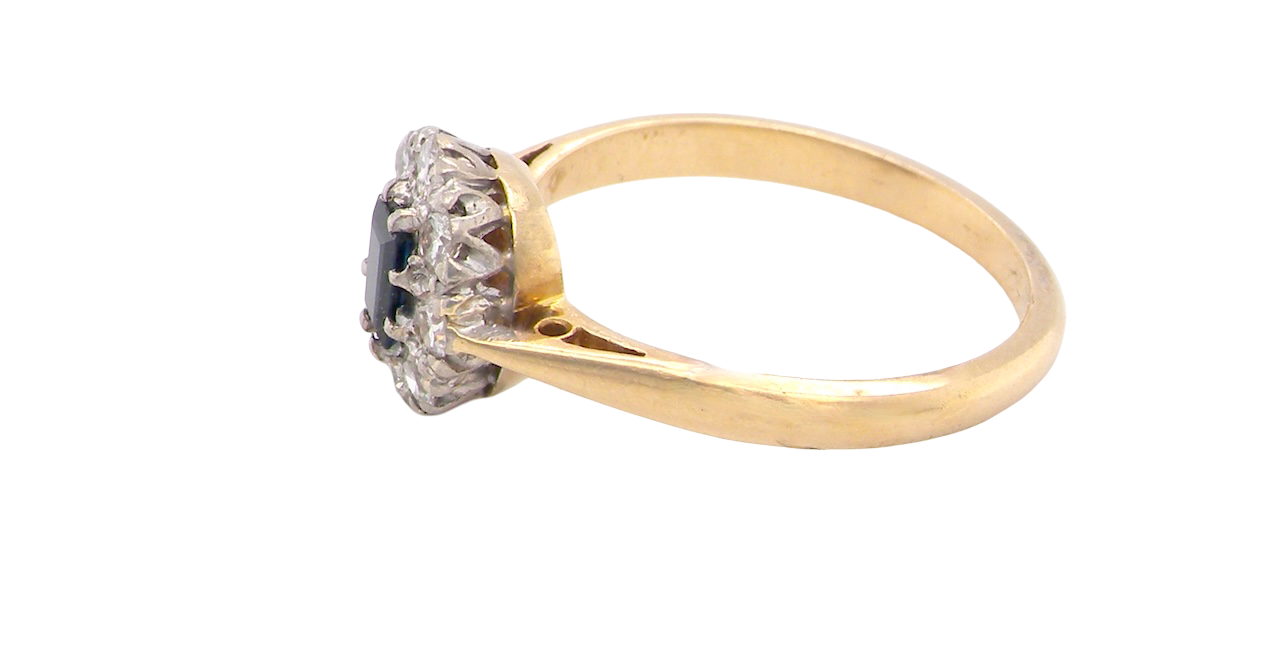 side A traditional 1970s cluster ring featuring a rectangular-cut sapphire,