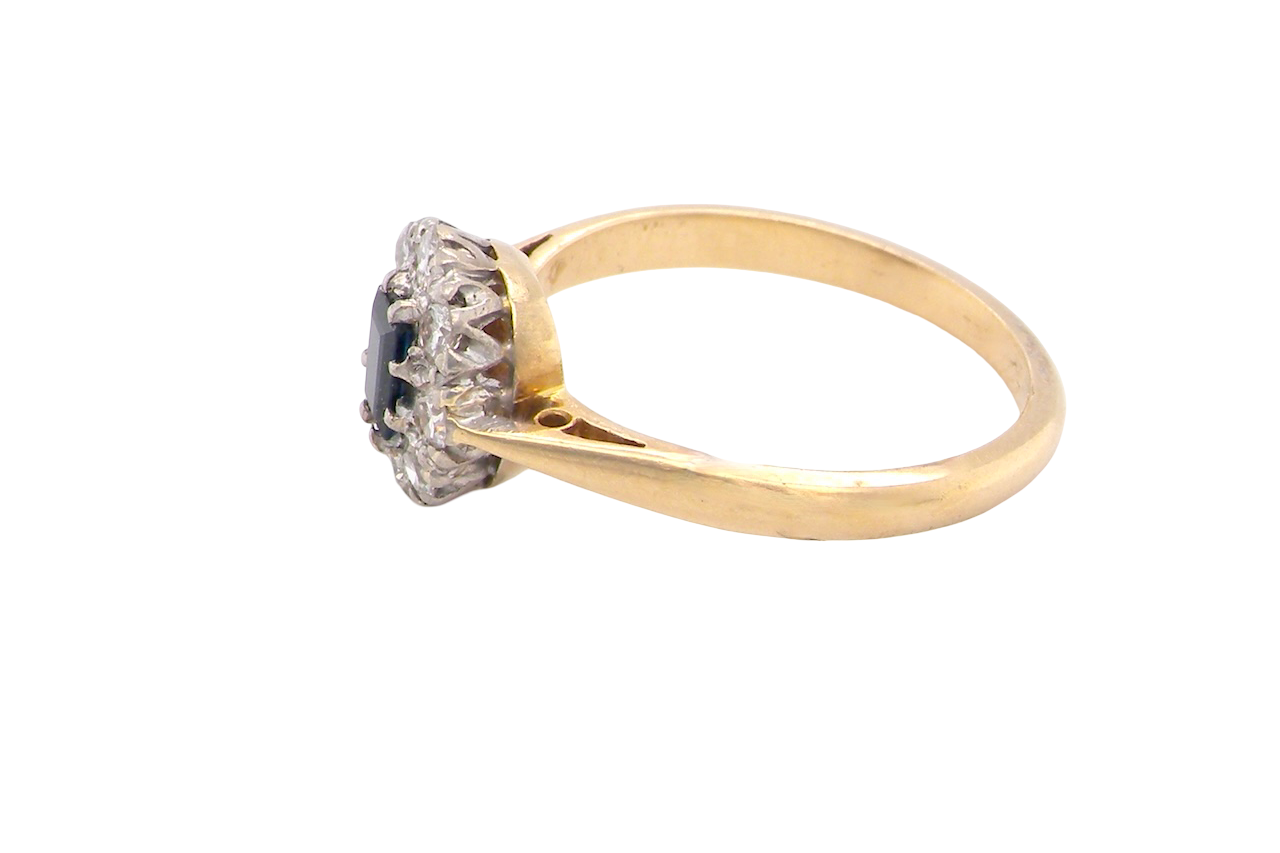 side A traditional 1970s cluster ring featuring a rectangular-cut sapphire,