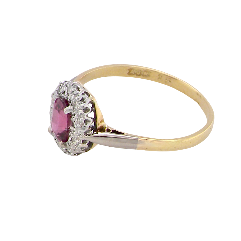side A traditional cluster ring. Features to the centre a dark pink red ruby, oval cut 6x4mm (0.50 carats)