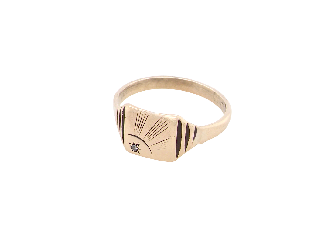 A unisex signet ring. Square head measures 8.5x8.5mm, sunray pattern side