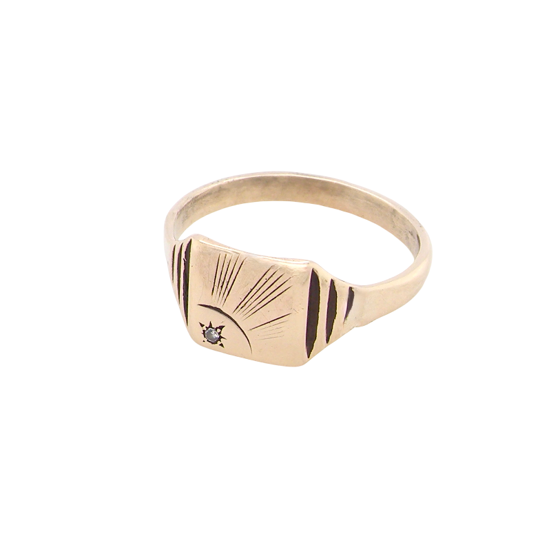 A unisex signet ring. Square head measures 8.5x8.5mm, sunray pattern side