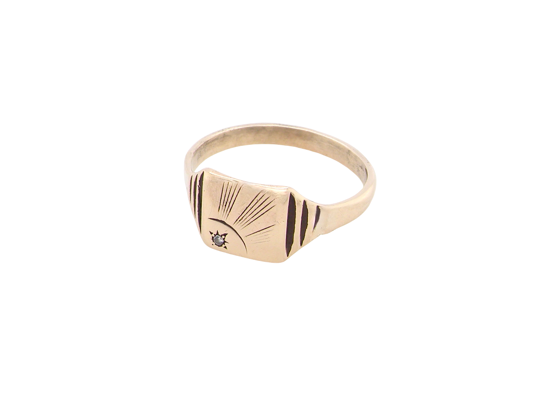 A unisex signet ring. Square head measures 8.5x8.5mm, sunray pattern side