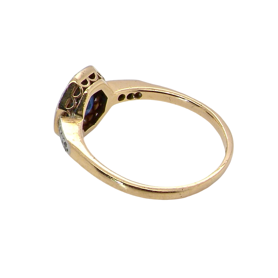 side A very pretty Art Deco cluster ring. To the centre a mid to dark blue sapphire, square cut but set as a 'diamond shape'. Measures 5x5mm, rim setting.