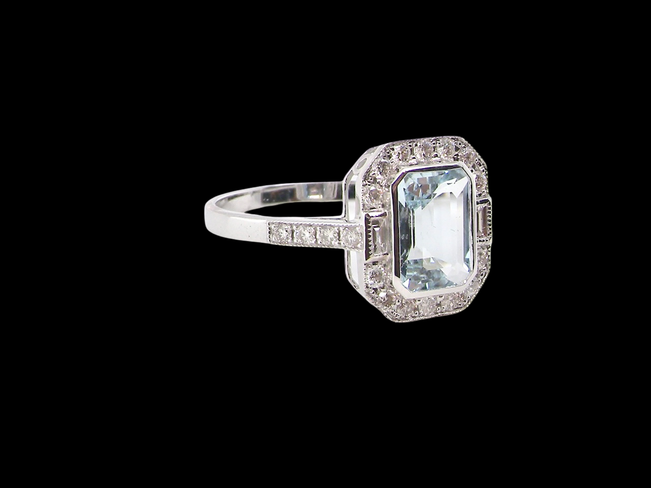 side A very pretty cluster ring. Features a step cut aquamarine centre stone, 8x7mm (est 1.21 carats). Plain rim setting.