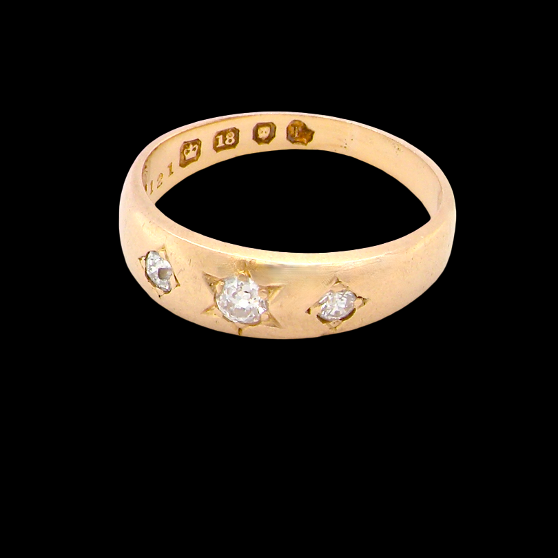 side A vintage 18 carat gold three stone ring. Set with brilliant cut white diamonds, cente 3mm, each side a 2.4mm diamond (total est 0.20 carats) Colour I-j, clarity Si. 