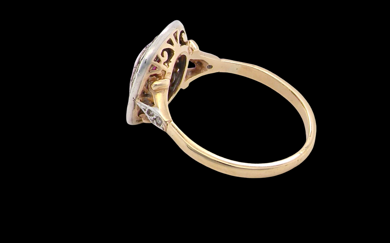 Gold ring with intricate design on a black background