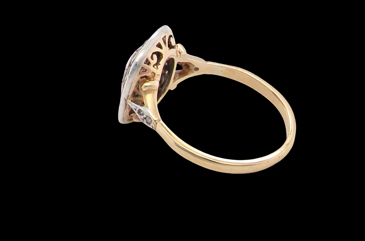 Gold ring with intricate design on a black background