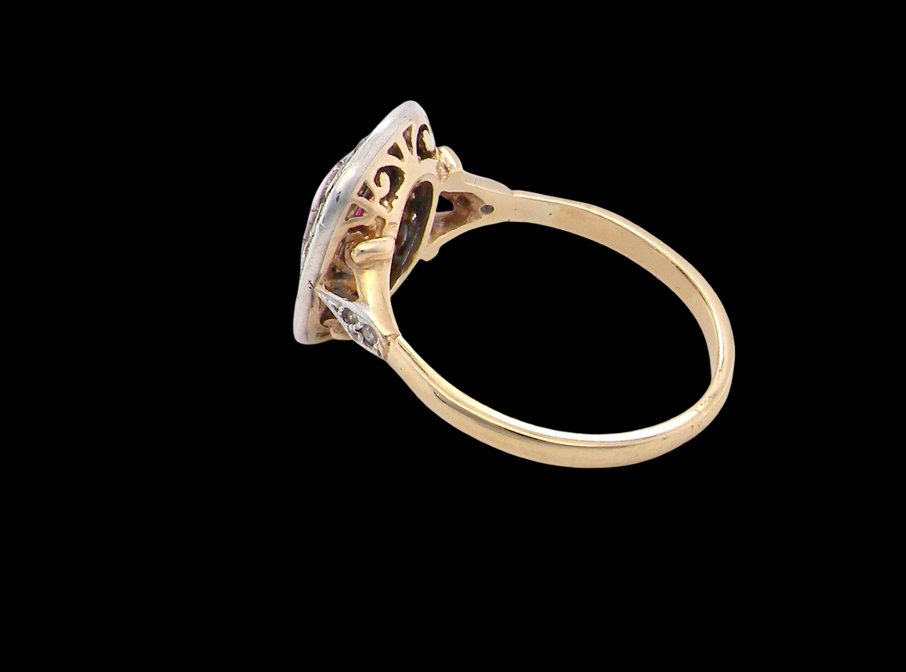 Gold ring with intricate design on a black background