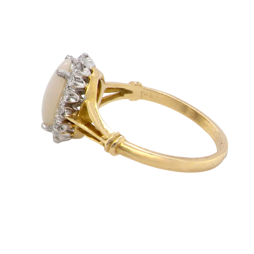 side A vintage cluster ring. Features an oval white opal, measures 10x8mm, with a good play of colour.