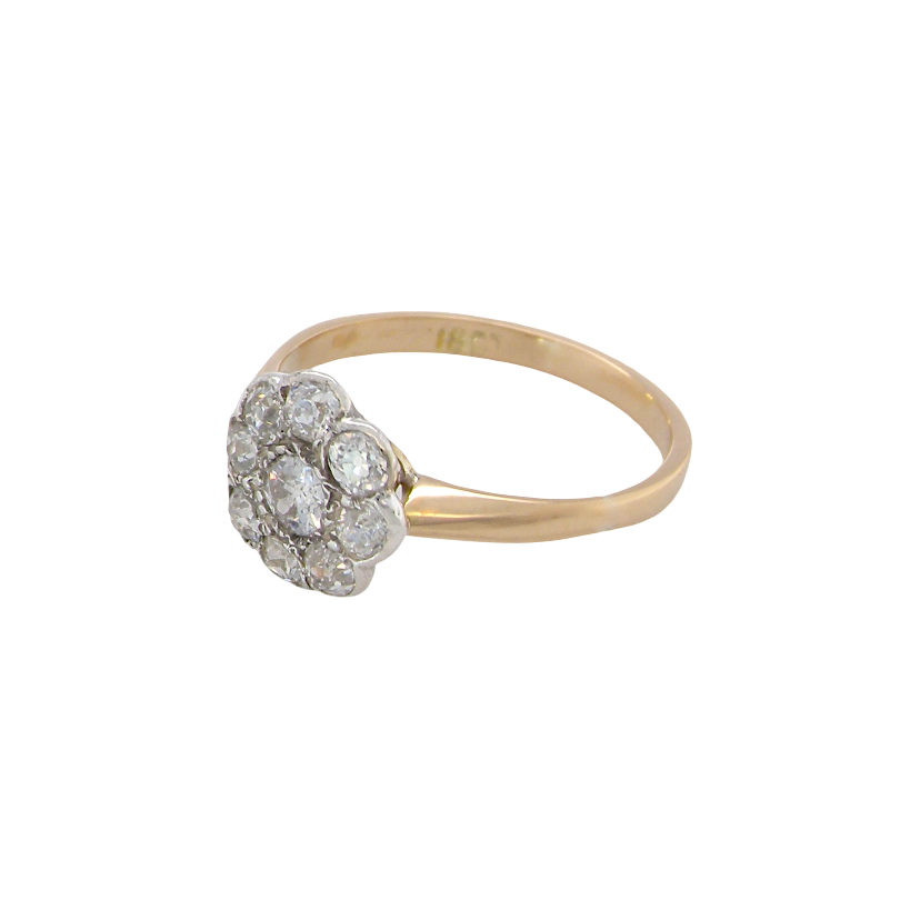 side A vintage cluster ring set with nine old brilliant cut white diamonds. Centre stone 3.7mm (est 0.18 carats) surorunded by eight 2.8mm diamonds (0.08 carats est).