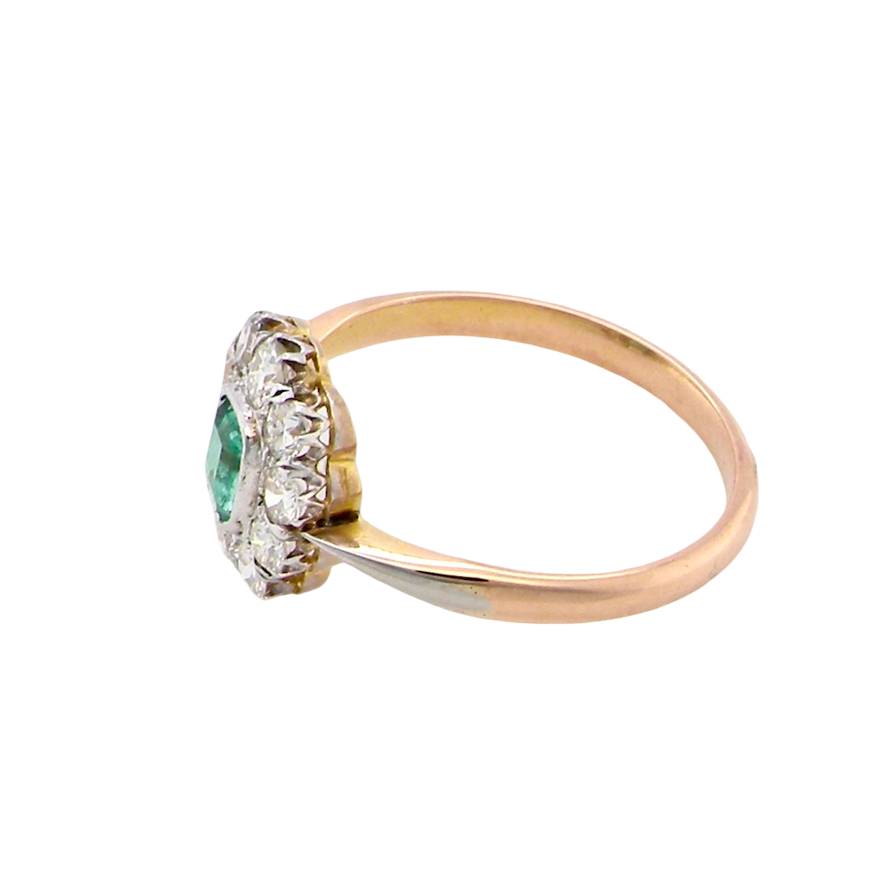 side A vintage cluster ring, the centre stone a cushion shaped emerald 4x3.5mm, mid to dark green colour. Mille grain setting.