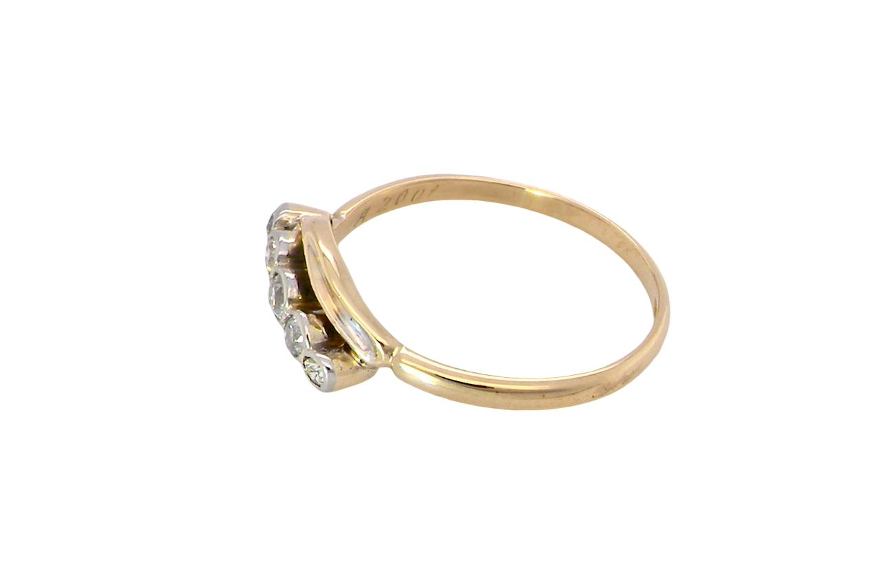side A vintage cross over style ring. Set with five old brilliant cut white diamonds. Centre stone 3mm, each side 2.4mm, each end 1.5mm. Total diamond content estimated at 0.22 carats.