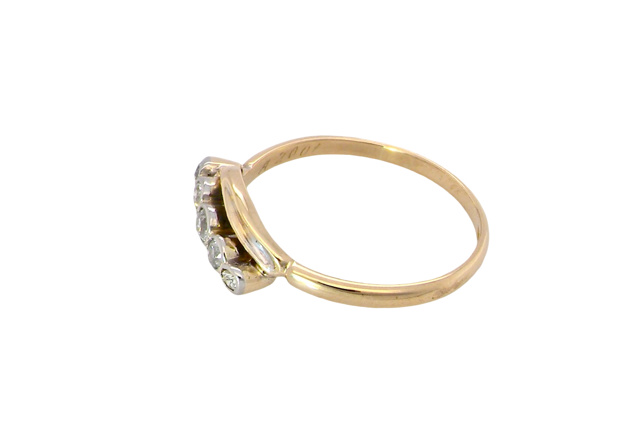 side A vintage cross over style ring. Set with five old brilliant cut white diamonds. Centre stone 3mm, each side 2.4mm, each end 1.5mm. Total diamond content estimated at 0.22 carats.