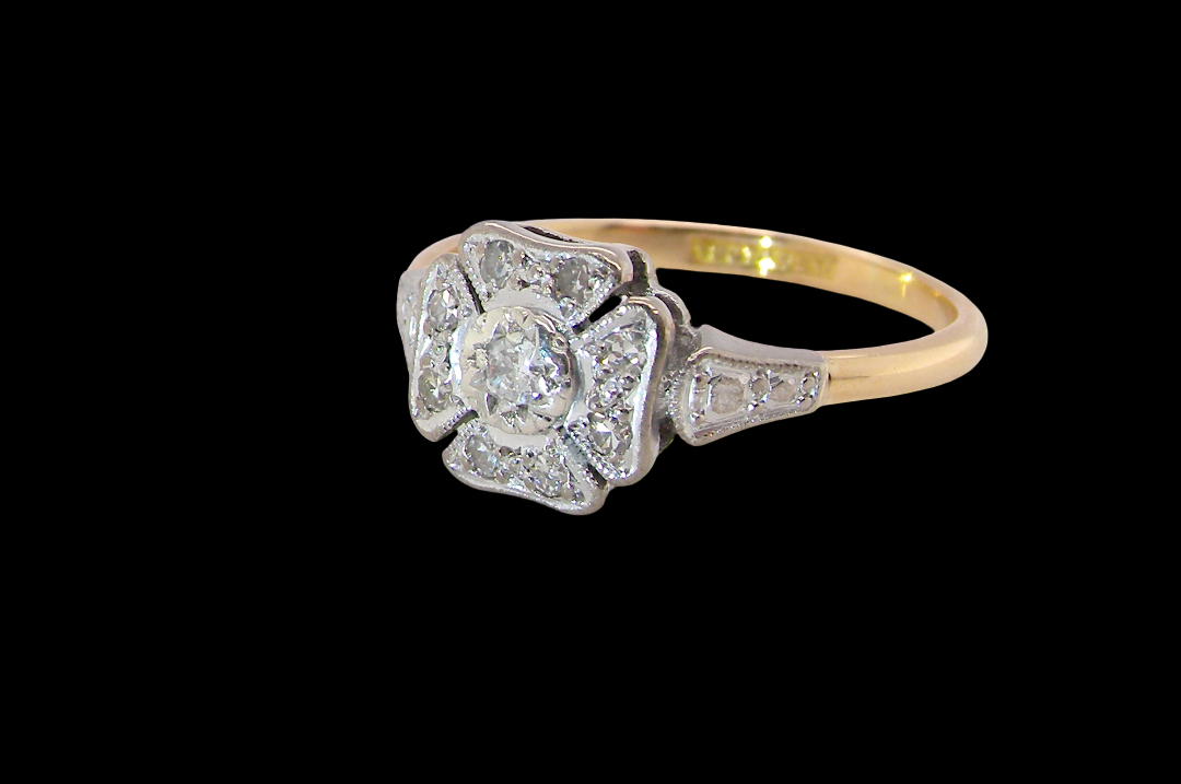 side A vintage diamond cluster ring. Shaped like a four leaf clover, each leaf is pavé set with small white diamonds, two each x 1.5mm. Centre diamond 2.4mm. (total estimated total 0.17 carats)