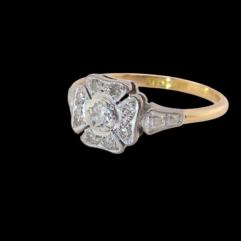 side A vintage diamond cluster ring. Shaped like a four leaf clover, each leaf is pavé set with small white diamonds, two each x 1.5mm. Centre diamond 2.4mm. (total estimated total 0.17 carats)
