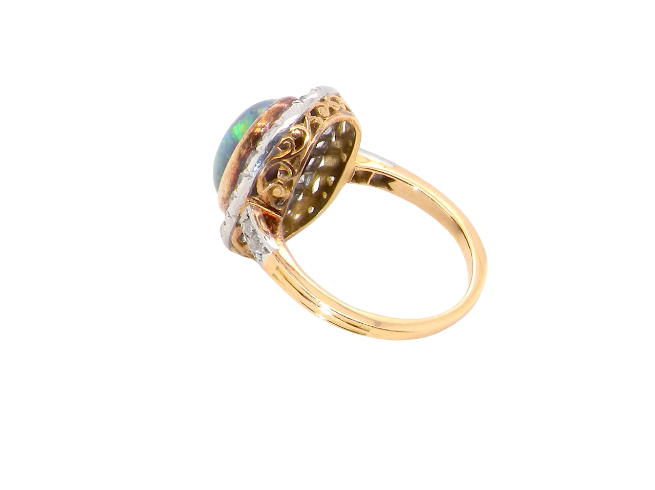 side A vintage early 20th century cluster ring. Features to the centre a black opal doublet, with an excellent play of colour, measures 9.5x7.5mm, in a rim setting.