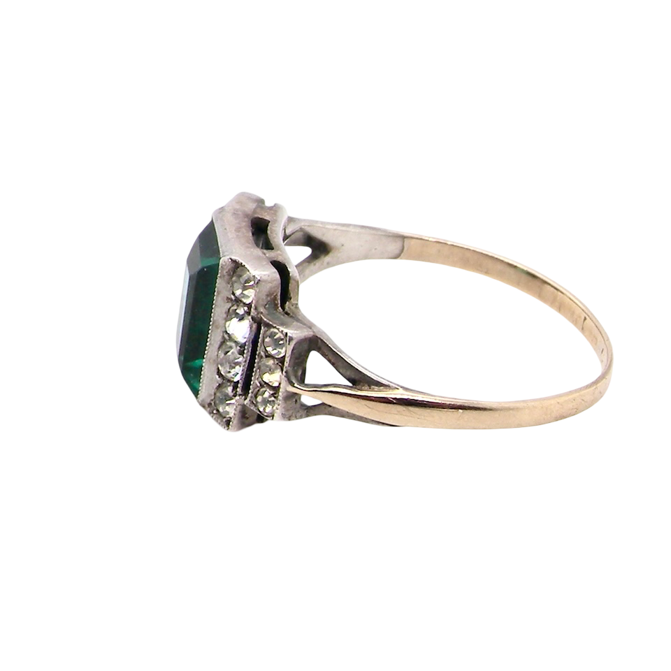 side A vintage early 20th century dress ring. The centre stone a vibrant crystal clear green paste stone, 8x6mm.
