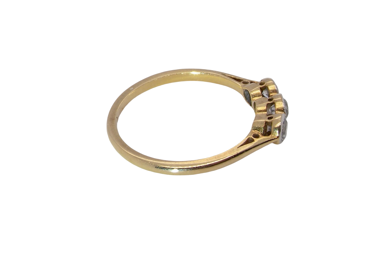 side A vintage early 20th century trilogy ring. Set with three old cut diamonds, centre stone 3.8mm, and each side a 3.6mm diamond (total carat weight estimated at 0.55 carats)