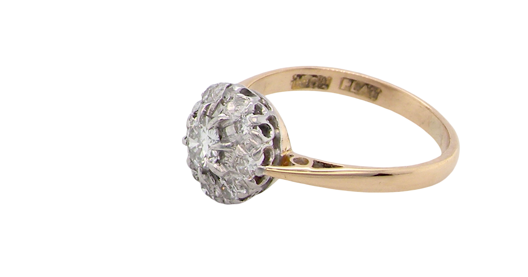 side A vintage mid 20th century cluster ring. Principle stone a brilliant cut white diamond, 4mm (0.25 carats est) clarity i-j, clarity Si.