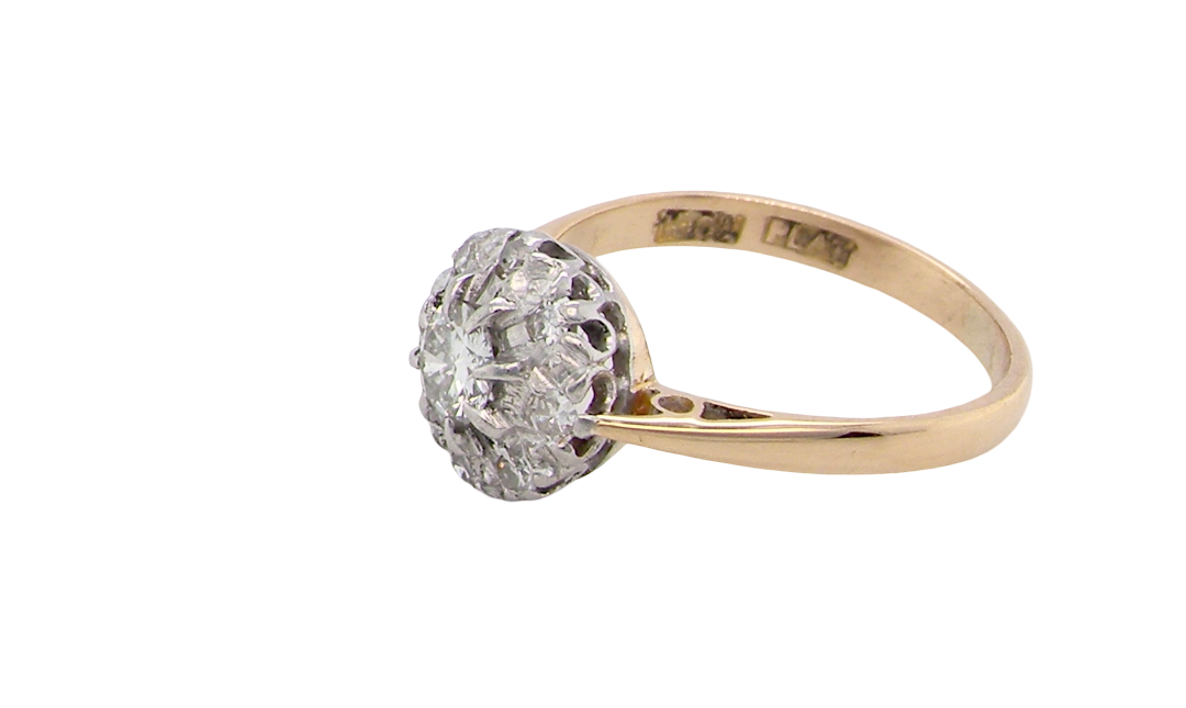 side A vintage mid 20th century cluster ring. Principle stone a brilliant cut white diamond, 4mm (0.25 carats est) clarity i-j, clarity Si.