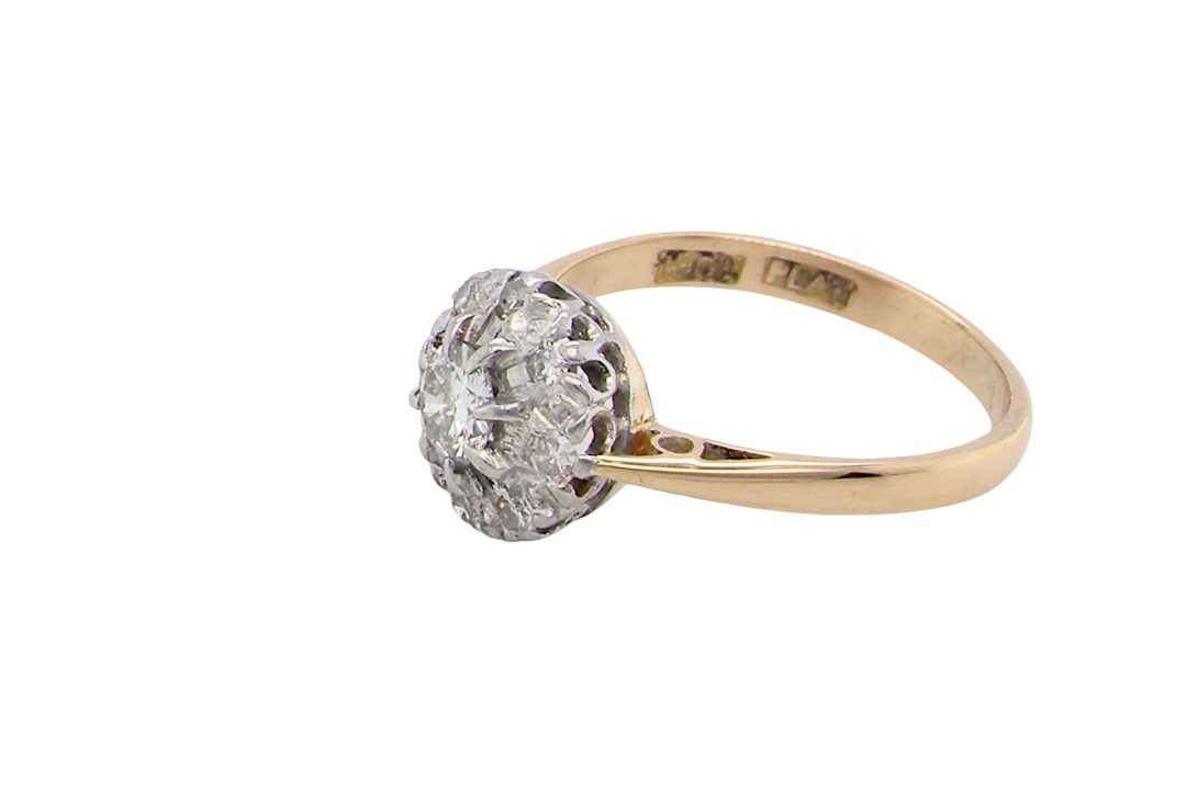 side A vintage mid 20th century cluster ring. Principle stone a brilliant cut white diamond, 4mm (0.25 carats est) clarity i-j, clarity Si.