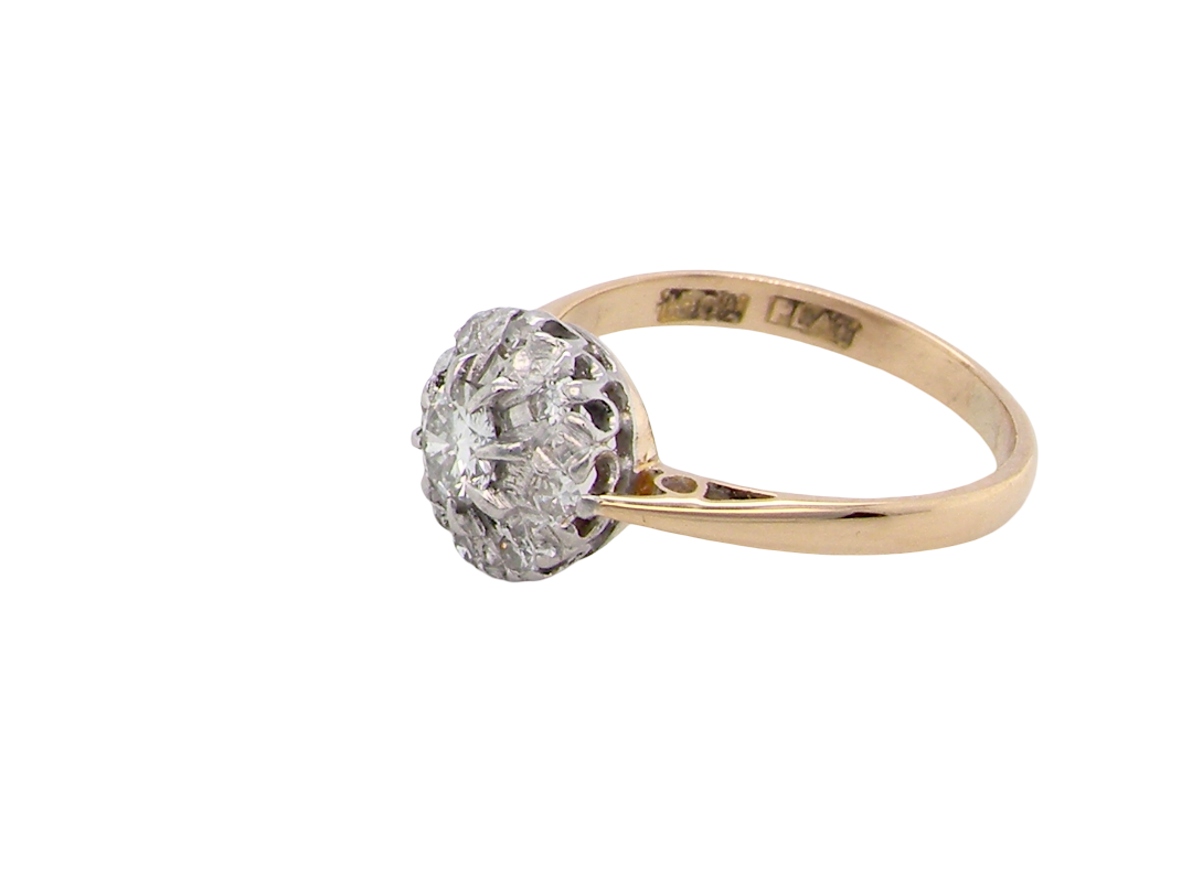side A vintage mid 20th century cluster ring. Principle stone a brilliant cut white diamond, 4mm (0.25 carats est) clarity i-j, clarity Si.