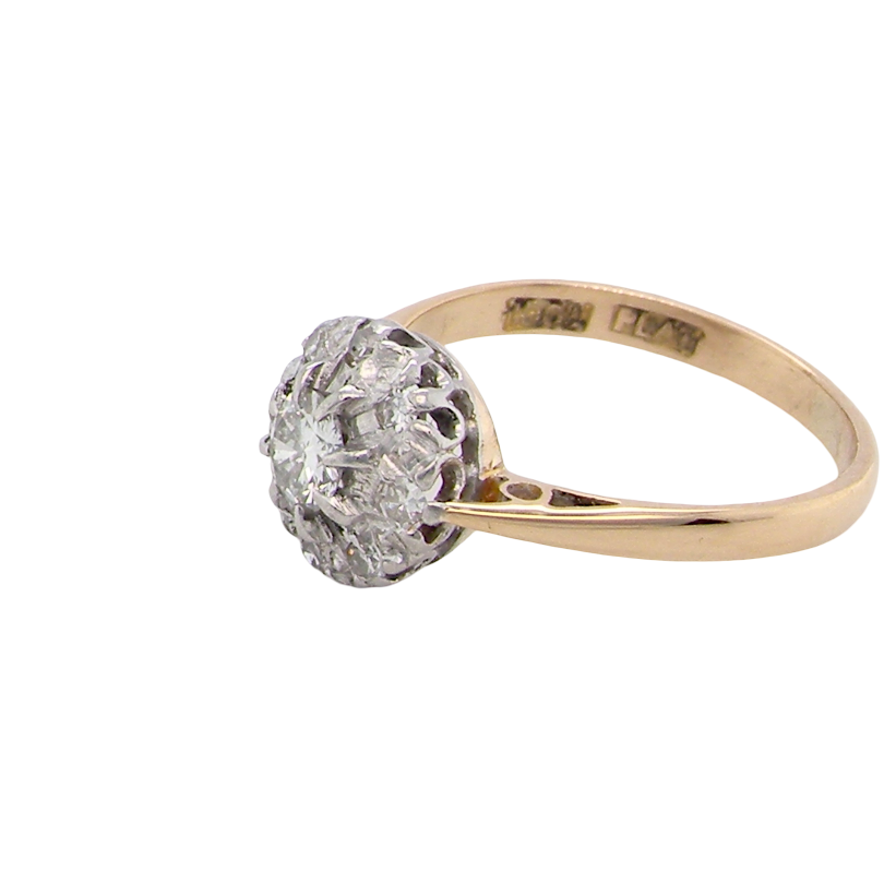side A vintage mid 20th century cluster ring. Principle stone a brilliant cut white diamond, 4mm (0.25 carats est) clarity i-j, clarity Si.