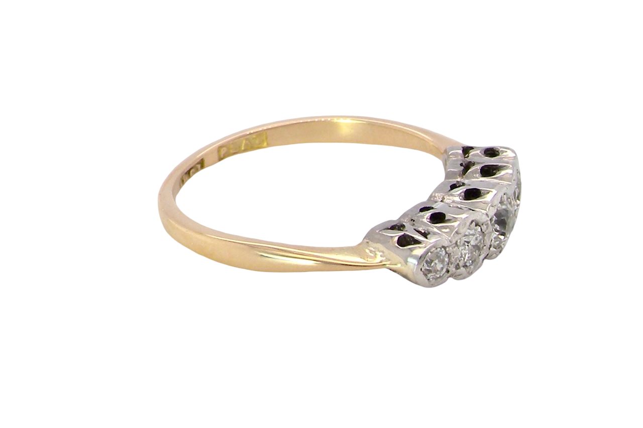 side A vintage ring containing five old brilliant cut white diamonds. Centre 3mm, each side 2.2mm, at each end a 1.8mm diamond. Total diamond content estimated at 0.25 carats. All illusion set in platinum