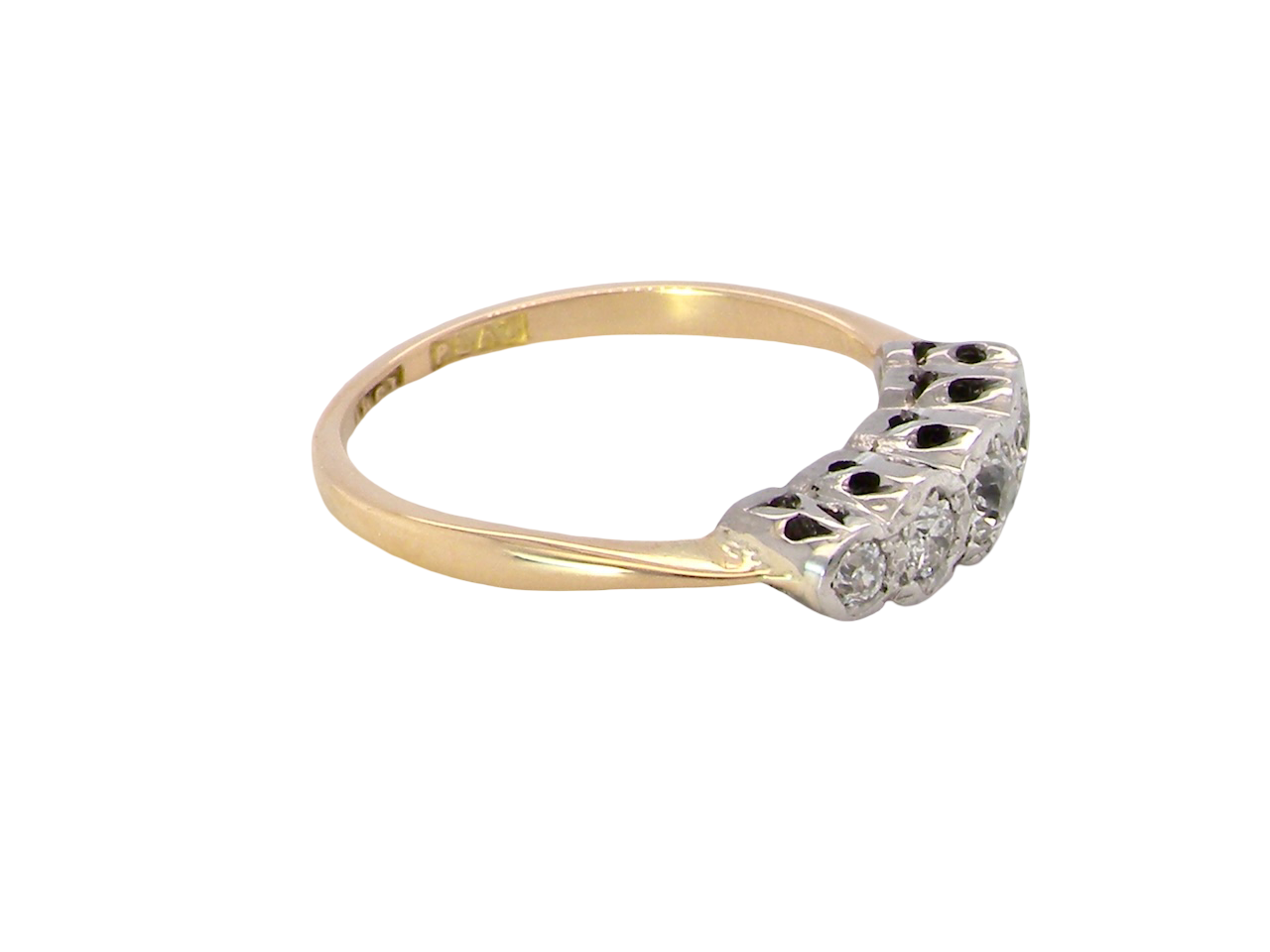 side A vintage ring containing five old brilliant cut white diamonds. Centre 3mm, each side 2.2mm, at each end a 1.8mm diamond. Total diamond content estimated at 0.25 carats. All illusion set in platinum