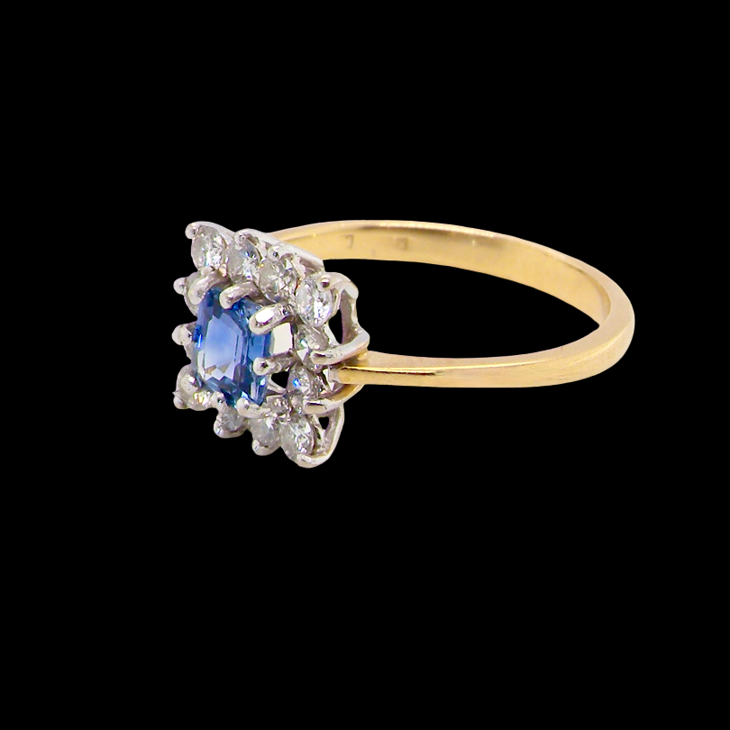 side A vintage square cluster ring. Features to the centre a square sapphire 5x5mm (est 0.50 carats) mid blue- cornflower hue. 