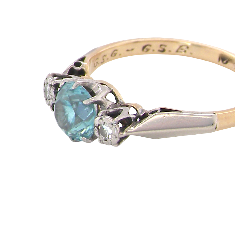 side A vintage three stone ring. Features to the centre a 6mm natural blue zircon, 6mm diameter, claw set.