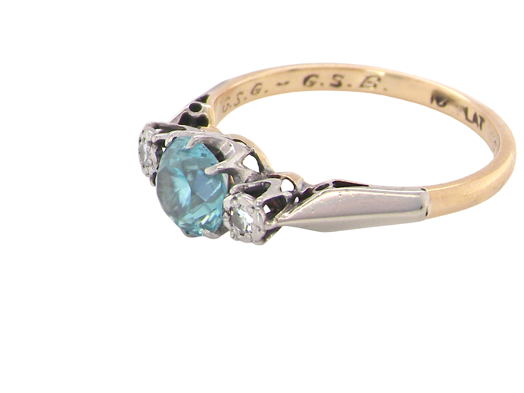 side A vintage three stone ring. Features to the centre a 6mm natural blue zircon, 6mm diameter, claw set.