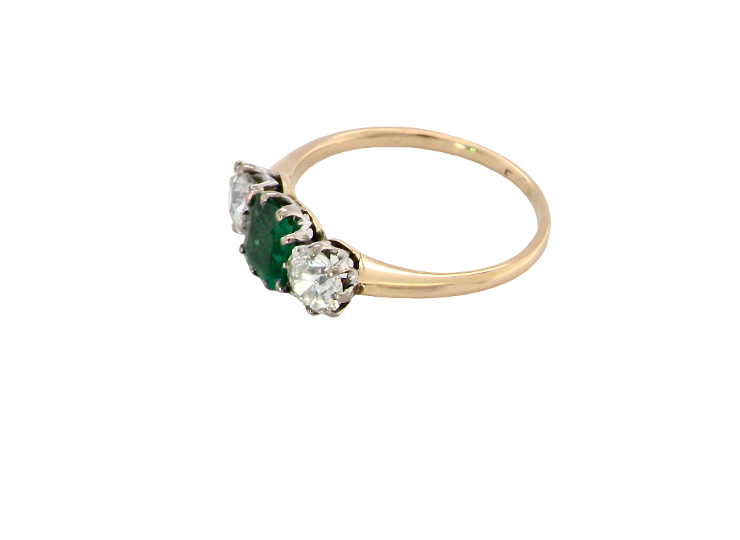 side A vintage trilogy ring. Centre stone a step cut emerald, 6.5x5.5mm (est .75 carats). The emerald is dark green.